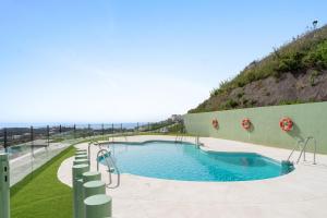 a swimming pool with a view of the ocean at Chic and stunning views on amazing terrace RDR484 in Mijas Costa