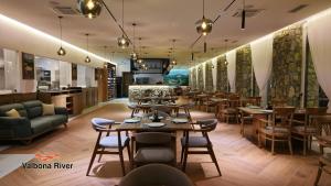 a restaurant with tables and chairs in a room at Valbona River Hotel in Jah Salih