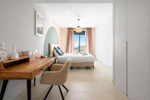 a bedroom with a bed and a desk and a bed at Chic and stunning views on amazing terrace RDR484 in Mijas Costa +12 photos