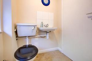 a bathroom with a toilet and a sink at Charming Hilltop Cottage with Panoramic Views in East Worldham +10 photos