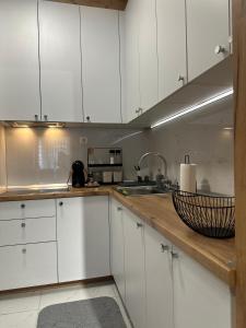 a kitchen with white cabinets and a counter top at Home apartment in Skopje
