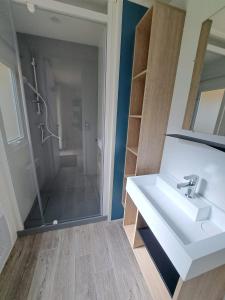 a bathroom with a sink and a shower at Camping Sainte Mère Eglise in Sainte-Mère-Église