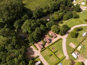 an overhead view of a park with trees and water at Glamping Retreats in Norwich +14 photos