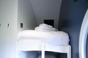 a pile of towels sitting on top of a bed at Retreats in Norwich