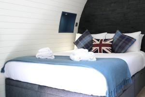 a bedroom with a bed with towels on it at Glamping Retreats in Norwich