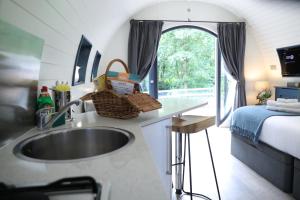 a kitchen with a sink in a tiny house at Glamping Retreats in Norwich