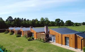 an image of a row of wooden houses in a field at River Bann Retreat in Portglenone