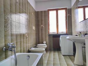 a bathroom with a tub and a toilet and a sink at IseoLakeRental - Villa Luna in Riva di Solto +20 photos