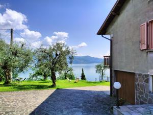 a house with a view of a lake at IseoLakeRental - Villa Luna in Riva di Solto
