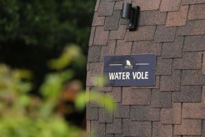 a sign on the side of a house that says water value at Retreats in Norwich +7 photos