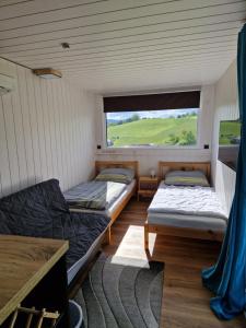 Postel nebo postele na pokoji v ubytování AktivQuartier Mühlviertel Tiny House