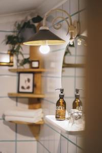 a bathroom with two bottles of soap on a shelf at Apartmenthaus Gasthof Burg Heimfels in Heinfels
