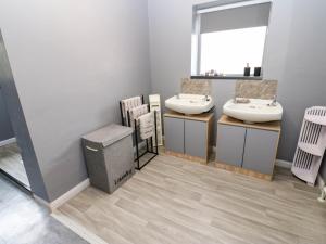 a bathroom with two sinks and a mirror at Newfield Apartment in Bishop Auckland +31 photos