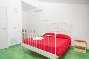 a bedroom with a red bed with a red blanket at Casa Margherita vista Etna in Calatabiano