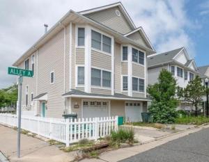 ein Haus mit einem weißen Zaun und einem Straßenschild in der Unterkunft Surfside Retreat- Close to Beach & Boardwalk! in Atlantic City