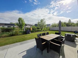 a table and chairs on a patio with a yard at Boise Cozy House in Boise