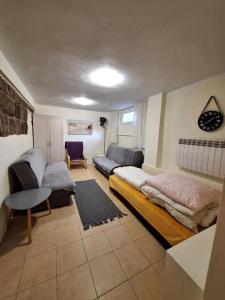 a living room with a bed and a couch at To Tu in Ruciane-Nida