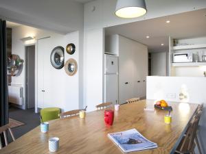 jadalnia z drewnianym stołem i kuchnią w obiekcie Appartement rénové 3 pièces · Balcon · Wifi gratuit · Parking inclus · Proche commerces & Transarc - FR-1-346-305 w mieście Arc 1800 +10 zdjęć