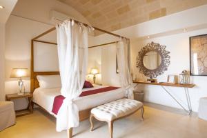 Postel nebo postele na pokoji v ubytování Masseriola Antiche Fogge by Apulia Hospitality