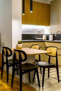 a kitchen with a table and chairs in a kitchen at Attica Skyline Living! in Athens