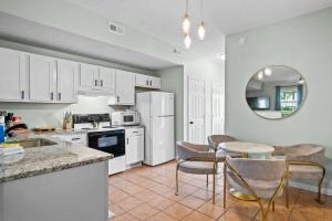 a kitchen with white appliances and a table and chairs at Lovely 3br Apartment for 7 - Near Ark Encounter in Williamstown