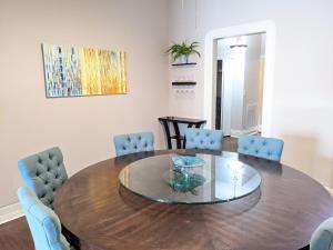 a dining room with a wooden table and blue chairs at Spacious Bronzeville Apartment in Chicago +17 photos