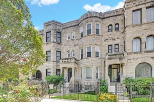 an old stone building with a fence in front of it at Spacious Bronzeville Apartment in Chicago