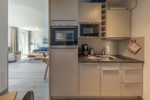 a kitchen with a sink and a counter top at Ferienwohnung Ostseesonne mit Balkon - direkt an der Ostsee gelegen in Zingst
