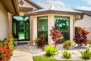 a house with plants in front of it at 3mins2Beach, Pool, FencedYard, Bikes, Patio, Office in Bonita Springs