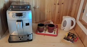 a coffee maker sitting on a counter next to a coffee pot at Osulai 18 in Santa Maria Navarrese