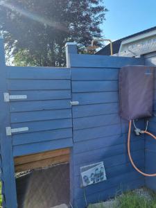 a blue fence with a sink and a chair at Falsterly Glamping in Horbelöv +12 photos