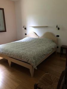 - une chambre avec un grand lit et deux lumières sur le mur dans l'établissement La Casa del Pettirosso, à Bagnacavallo