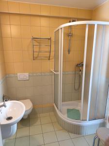 a bathroom with a shower and a toilet and a sink at Pokoje gościnne in Międzyzdroje +24 photos
