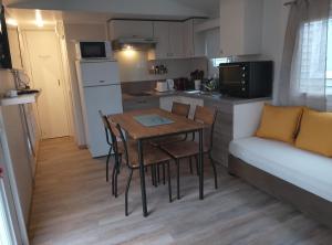 a kitchen and dining room with a table and a couch at Joseli in Fréjus
