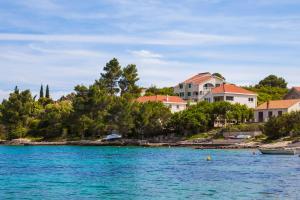 a group of houses on the shore of a body of water at Apartments Chiara in Korčula