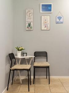 two chairs and a table in a room with a wall at La Piazza Hotel in Shumen +53 photos