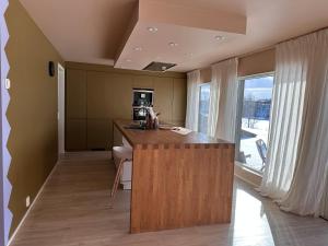 a kitchen with a island in the middle of a room at Tana Panorama - Apartments in Tana