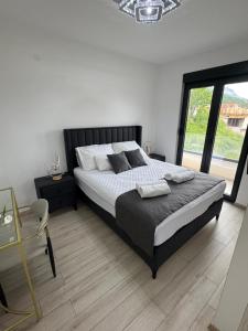 a bedroom with a large bed and a large window at S-Penthouse in Herceg-Novi +36 photos