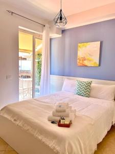 a bedroom with a large white bed with a blue wall at Blue Tide - Tropea in Tropea +25 photos