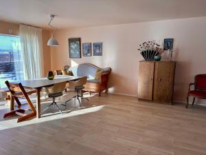 a living room with a table and chairs at Tana Panorama - Apartments in Tana +17 photos