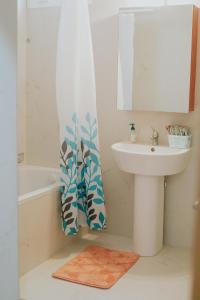 a bathroom with a sink and a mirror at Eukalyptos 3BD apartment with yard in Chersonisos in Hersonissos