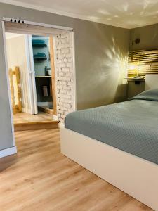 a bedroom with a bed and a brick wall at CityLoft Milano, two meters from metro station for the Duomo in Milan +35 photos