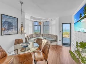 a living room with a glass table and chairs at Granada Apartments Berkeley in Blackpool