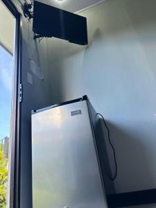 a refrigerator freezer sitting next to a wall at Residencia Esmeralda in Agua Buena