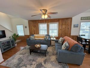 a living room with two couches and a ceiling fan at KD108- Into the Mystic in Kill Devil Hills