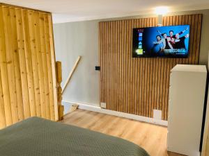 a bedroom with a tv on the wall and a bed at CityLoft Milano, two meters from metro station for the Duomo in Milan