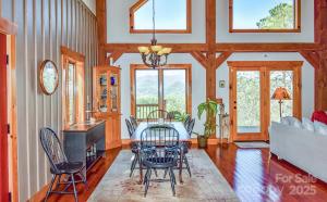 a dining room with a table and chairs at Chasing Sunsets: A Cozy 2-Bedroom Cabin in Smoky Mts with Stunning Mountain Views. in Whittier