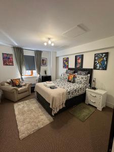a bedroom with a bed and a couch in it at LoughView BED & BREAKFAST in Belfast