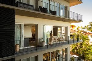 a woman walking on the balcony of a building at Pacifica by Pardela in Bucerías
