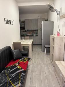 a kitchen with a couch and a table and a refrigerator at Casa sharm in Bologna